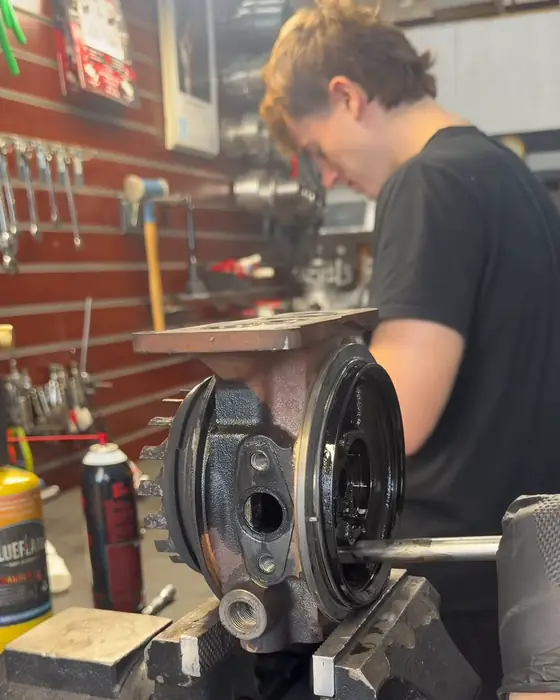 A technician working on a turbocharger in the Turbo Reman Center shop