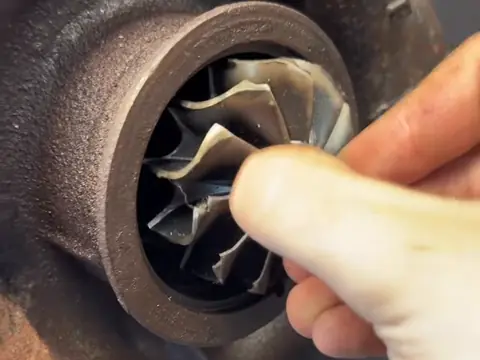 A damaged turbo wheel with bent blades