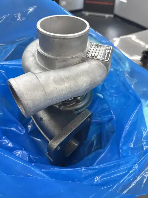 Remanufactured turbocharger on a blue protective wrap